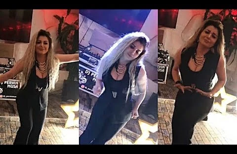 Azərbaycanlı müğənni əlində içki kişilərin qucağında rəqs etdi